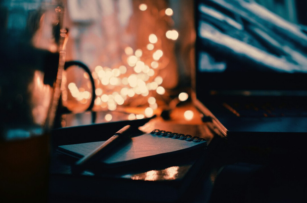 person writing in journal at night